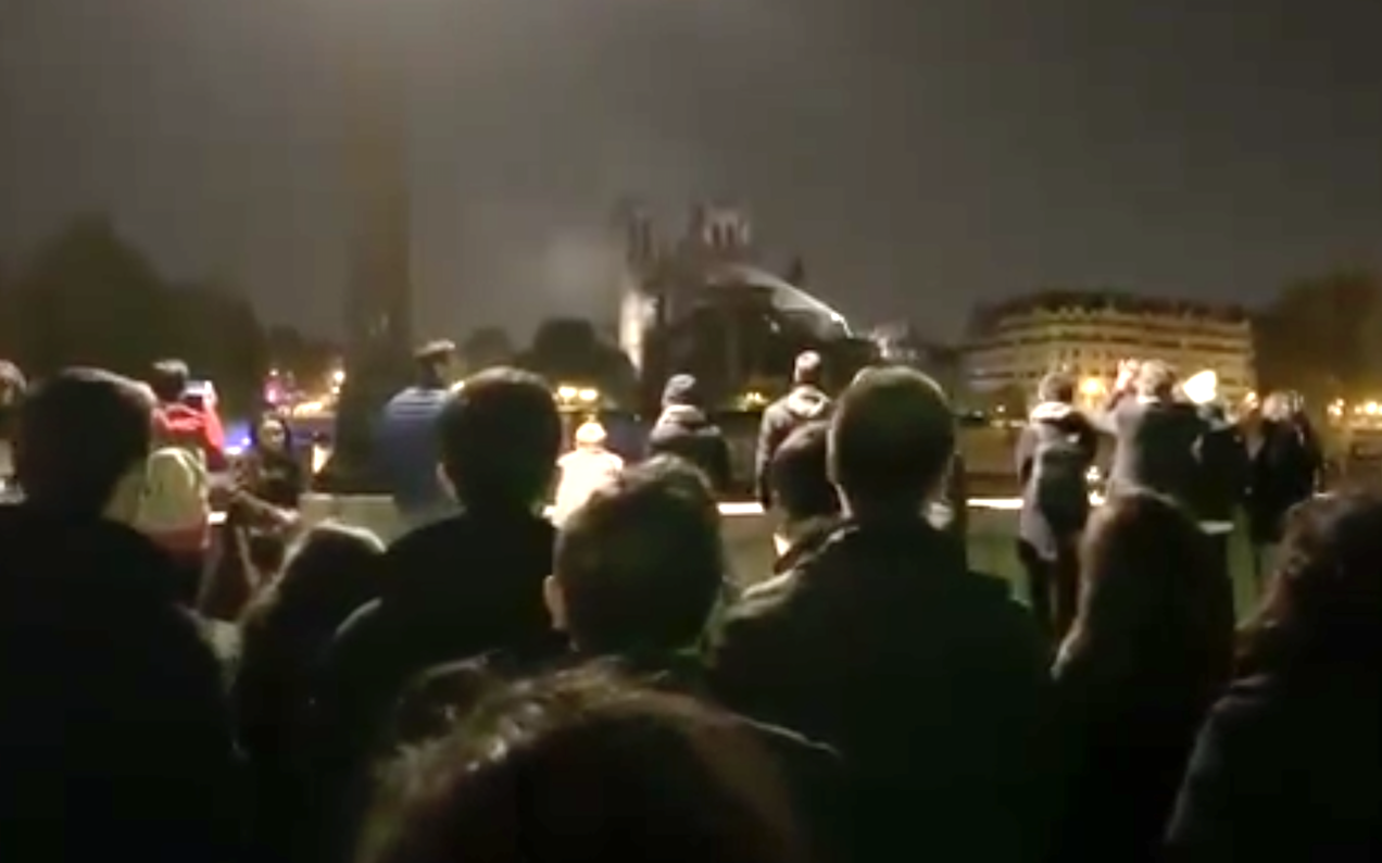 WATCH: Mourners Sing Hymns Into The Night Outside Notre Dame Cathedral