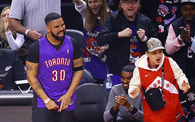 Drake Is Trolling Steph Curry By Wearing His Dad’s Old Raptors Jersey