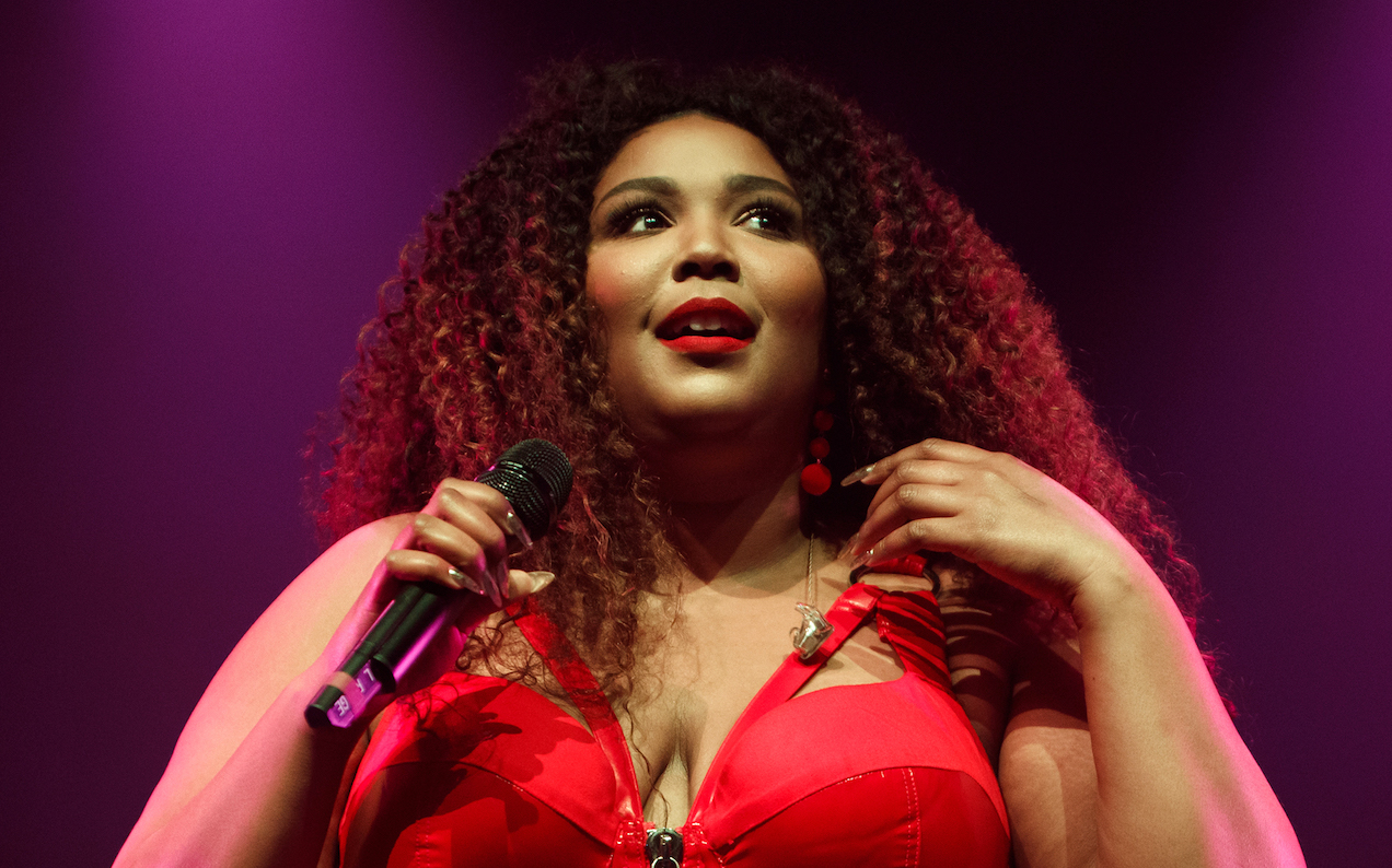 A Singer Is Claiming Lizzo Stole The ‘100% That Bitch’ Lyric From Her & It’s Messy As Hell