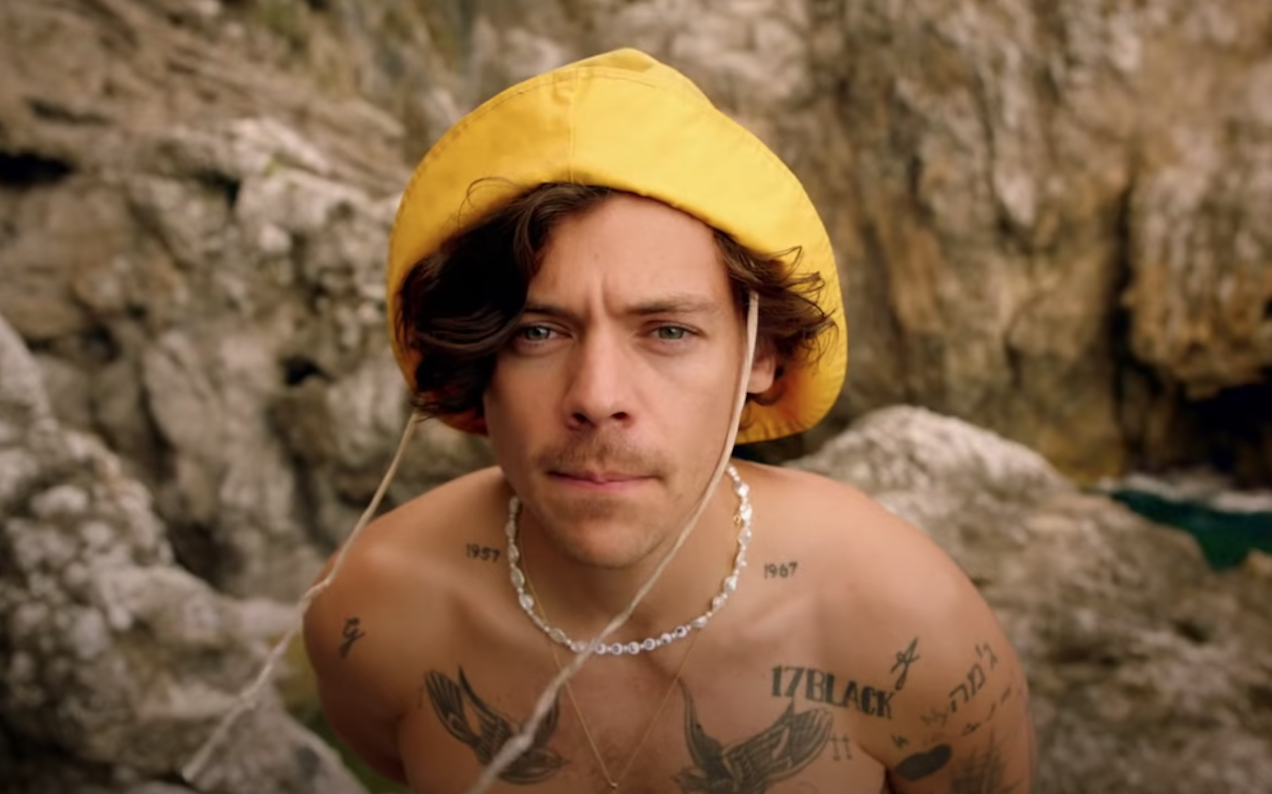 Harry Styles’ New Golden Clip Is A Love Letter To Running Around And Taking Off Your Shirt