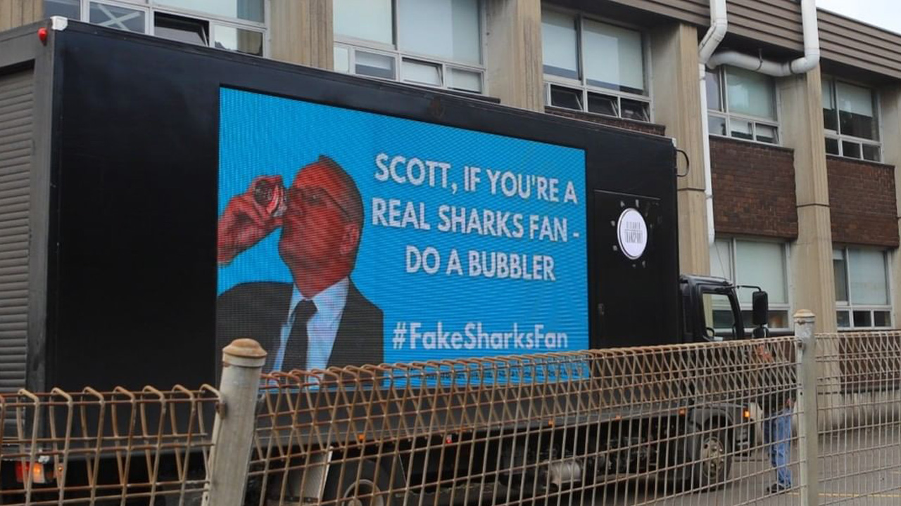 Billboards Hooning Around Syd Are Questioning Whether Morrison Is *Actually* A Sharkies Fan